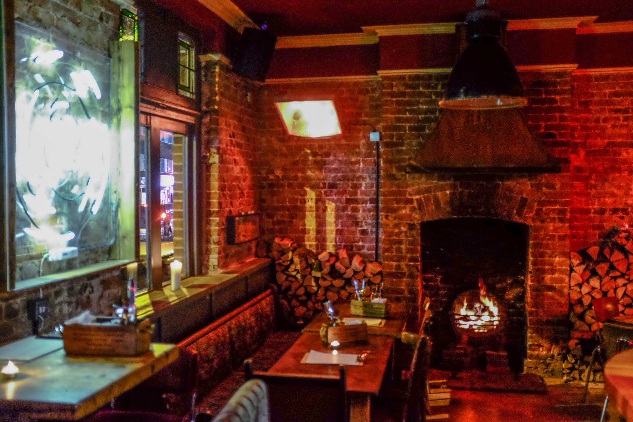 Cozy semi-private pub area with exposed brick, ideal for corporate retreats and networking.