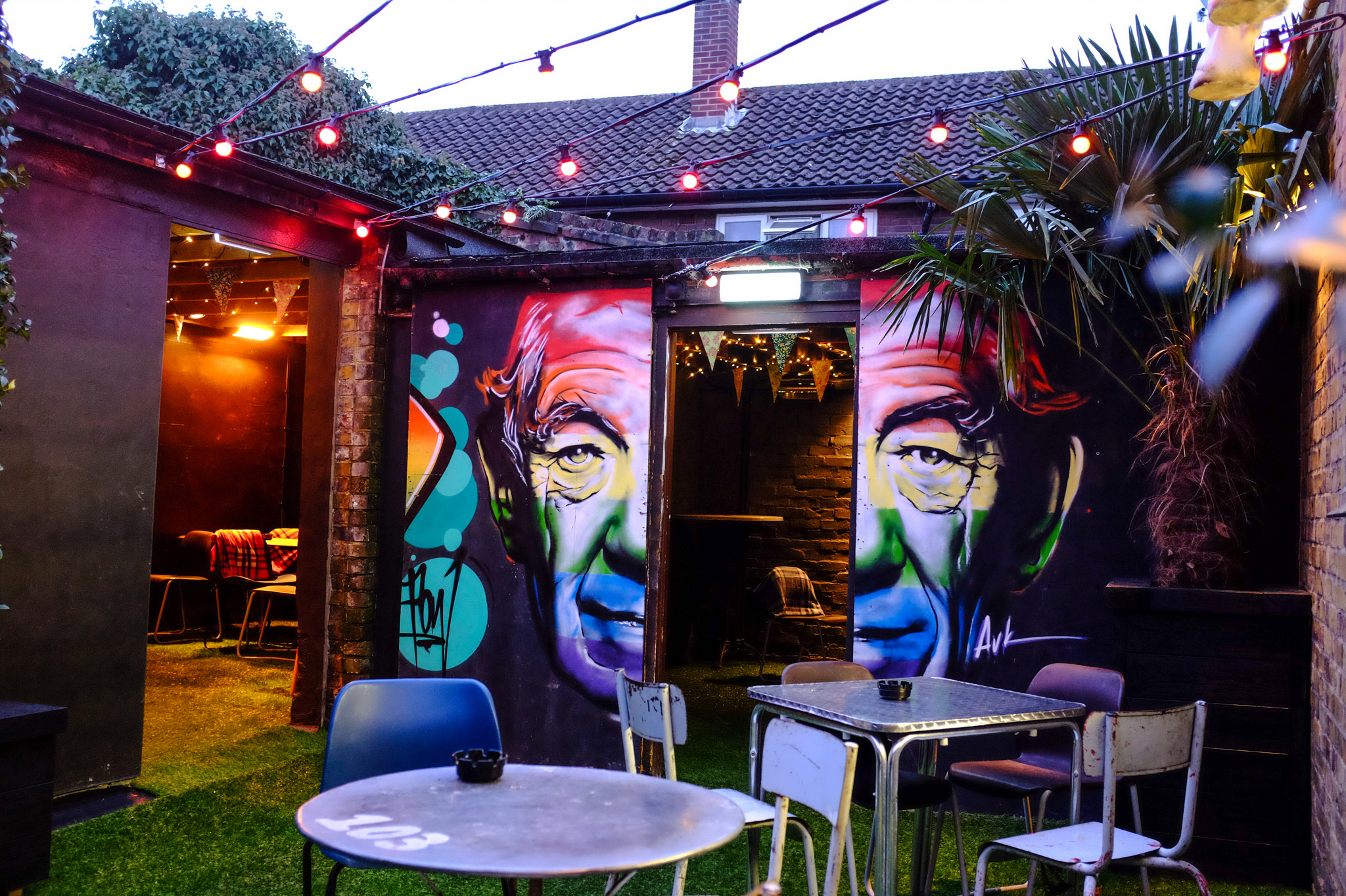 Semi-private garden at Ladywell Tavern with mural art for vibrant outdoor events.