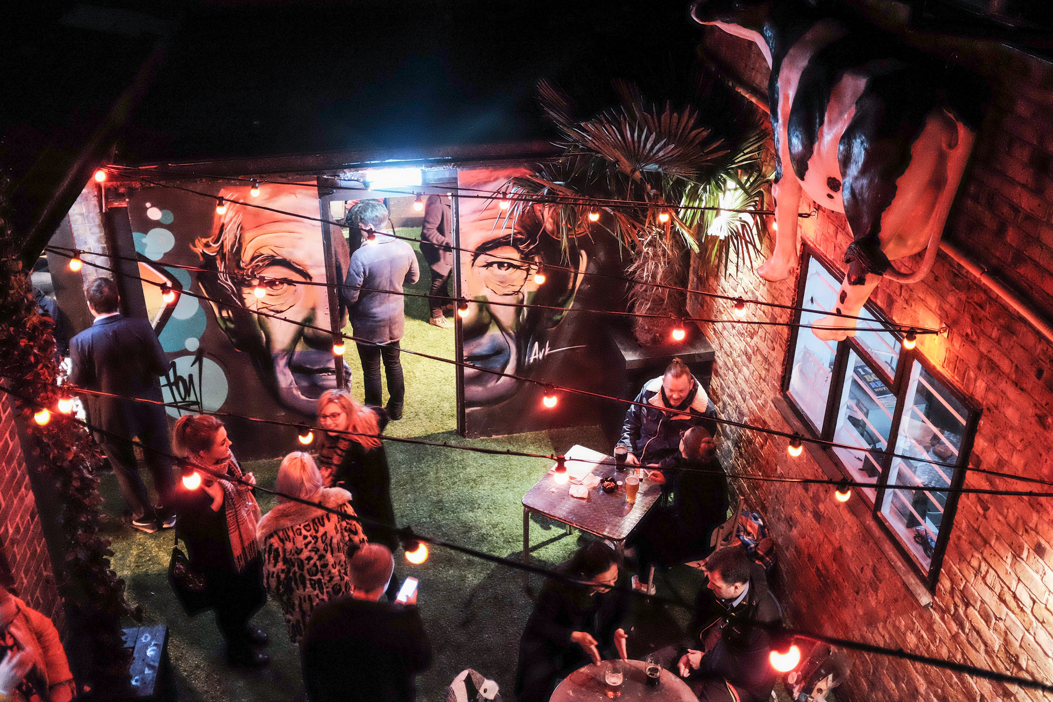 Semi-private garden at Ladywell Tavern with murals, ideal for social gatherings and events.