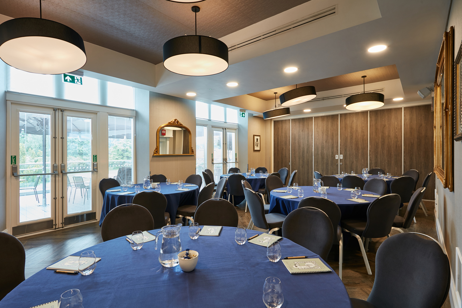 Intimate meeting space with blue linens at Oddfellows On The Park for events.