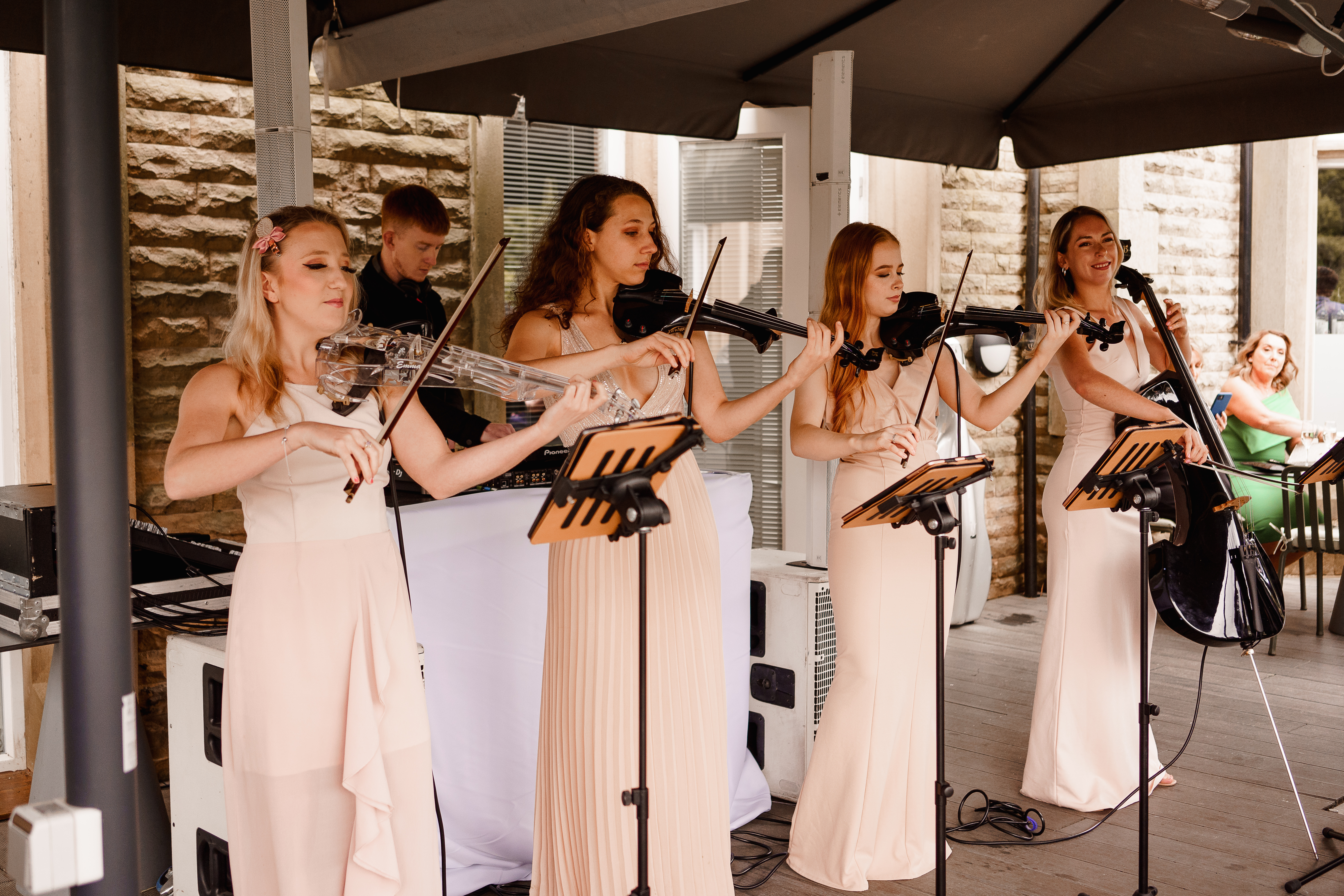 String quartet performing elegantly at outdoor wedding event in The Parlor Rooms.