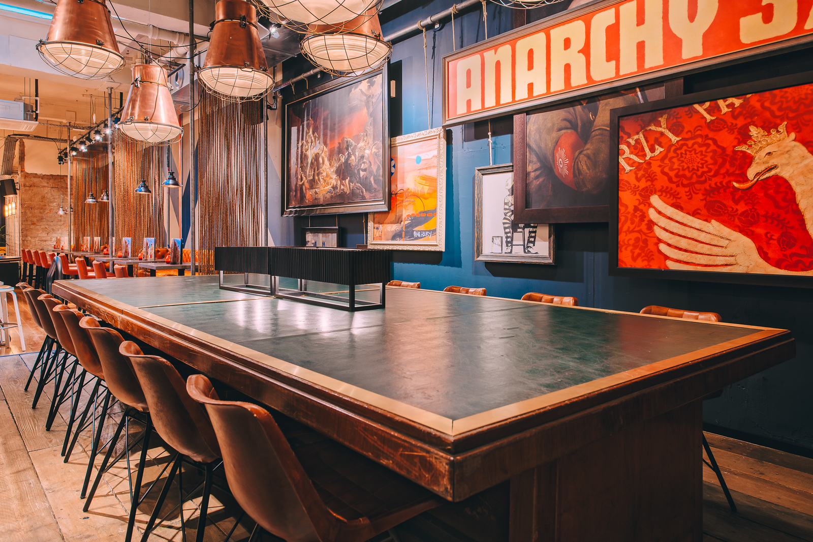 Stylish meeting space in Glasgow library with inviting table and modern chairs.