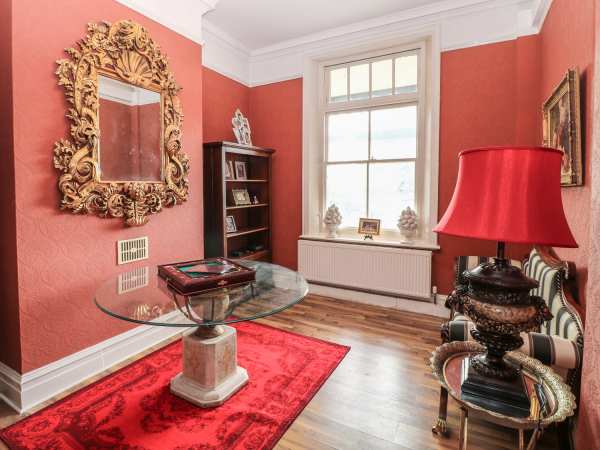Stylish meeting space in Peak Manor with rich red walls, ideal for networking events.