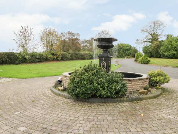 Charming outdoor venue at Peak Manor with fountain, perfect for weddings and retreats.