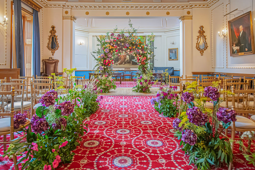 Weddings at Stationers' Hall with vibrant floral decor and elegant seating.