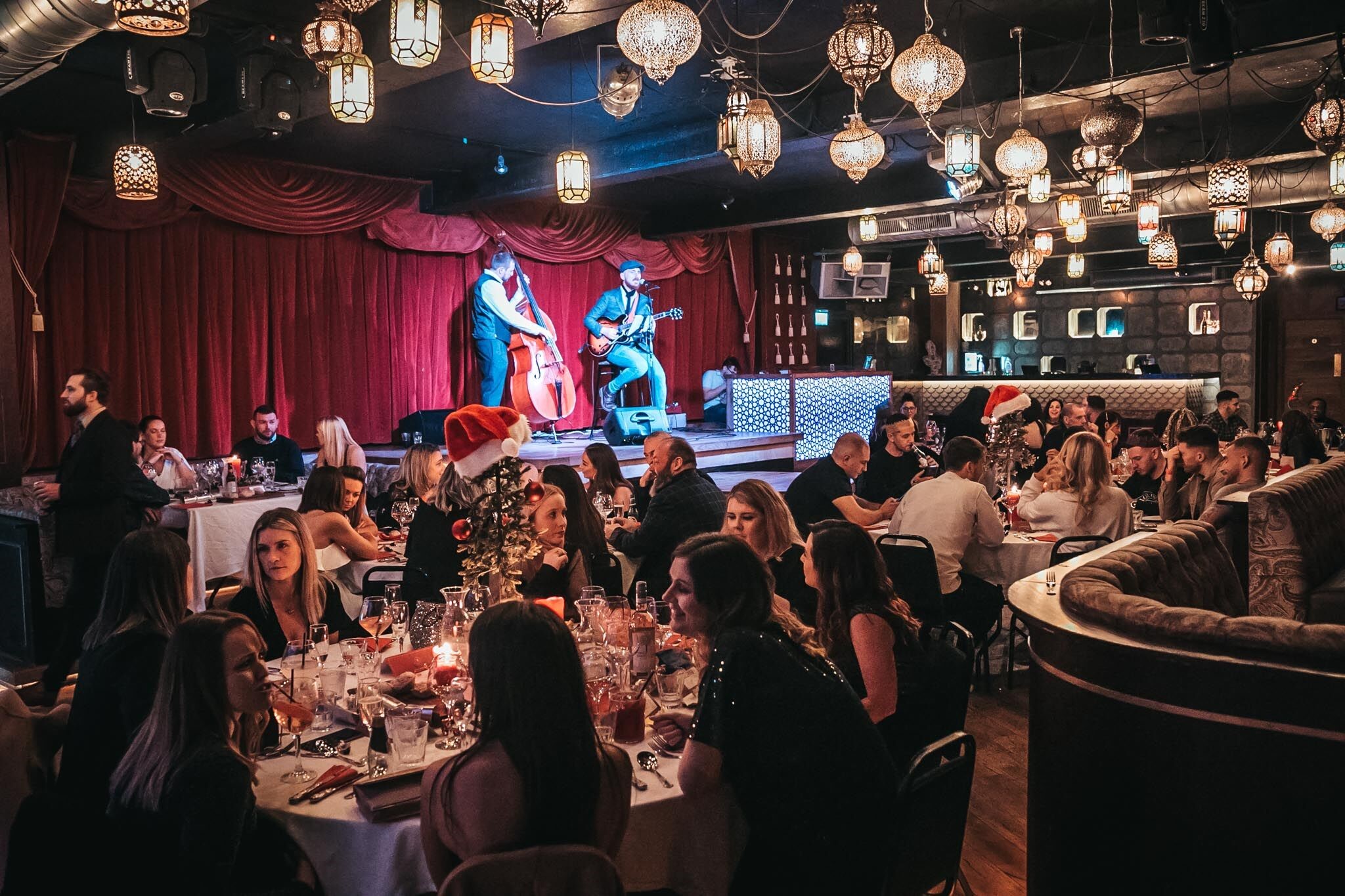 Vibrant Impossible Theatre event space with live performers for corporate events and parties.