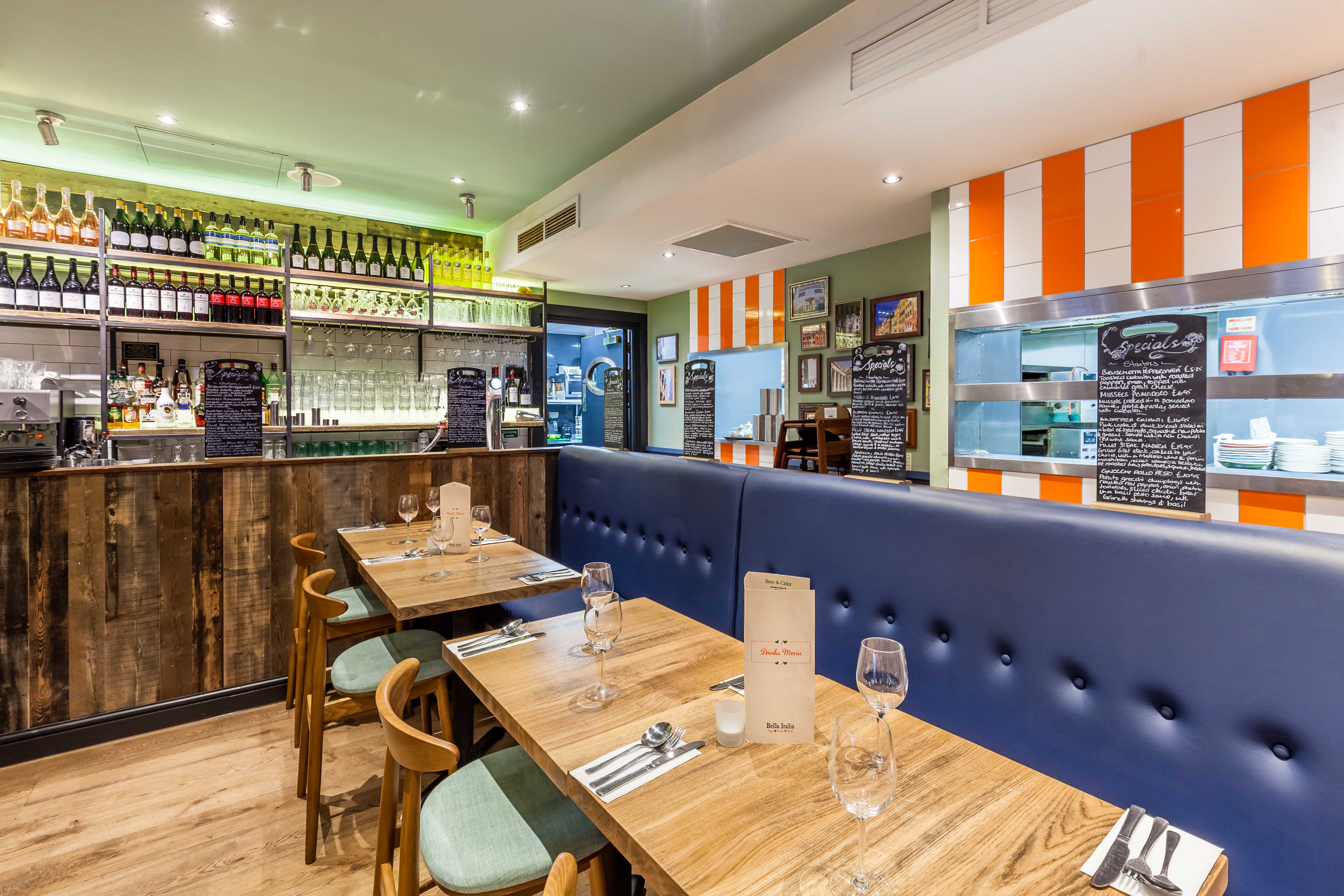 Modern restaurant interior with blue seating, ideal for intimate gatherings and corporate events.