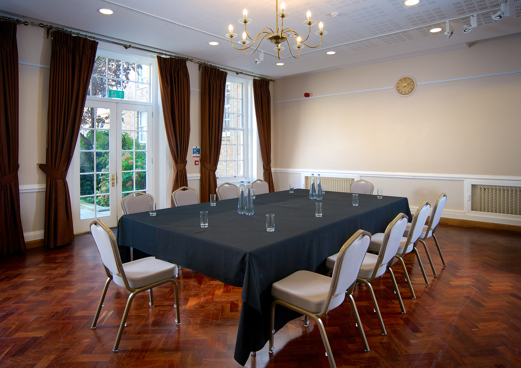 William Goodenough Small Common Room with elegant chandelier for meetings and gatherings.