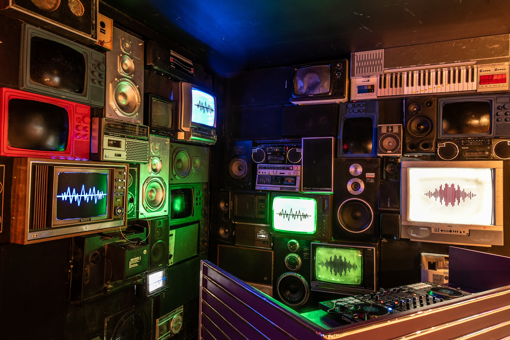 Vibrant bar area with retro audio-visual setup for workshops and networking events.