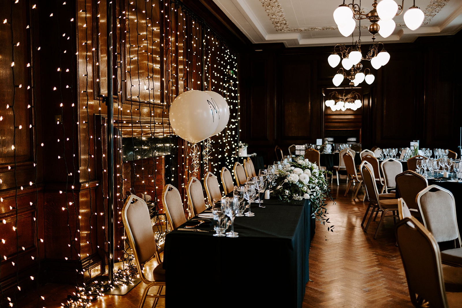 Elegant event space in Manchester Hall with floral decor and fairy lights. Perfect for celebrations.