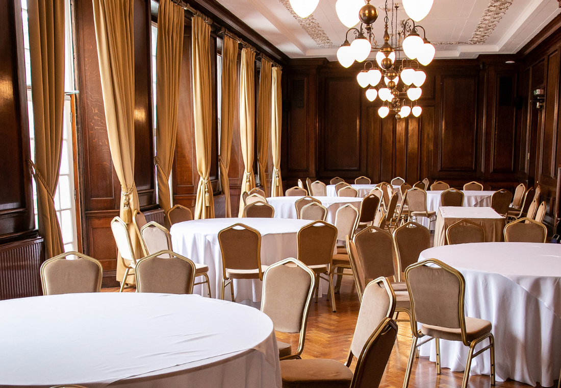 Elegant event space in Manchester Hall with round tables, ideal for conferences and banquets.