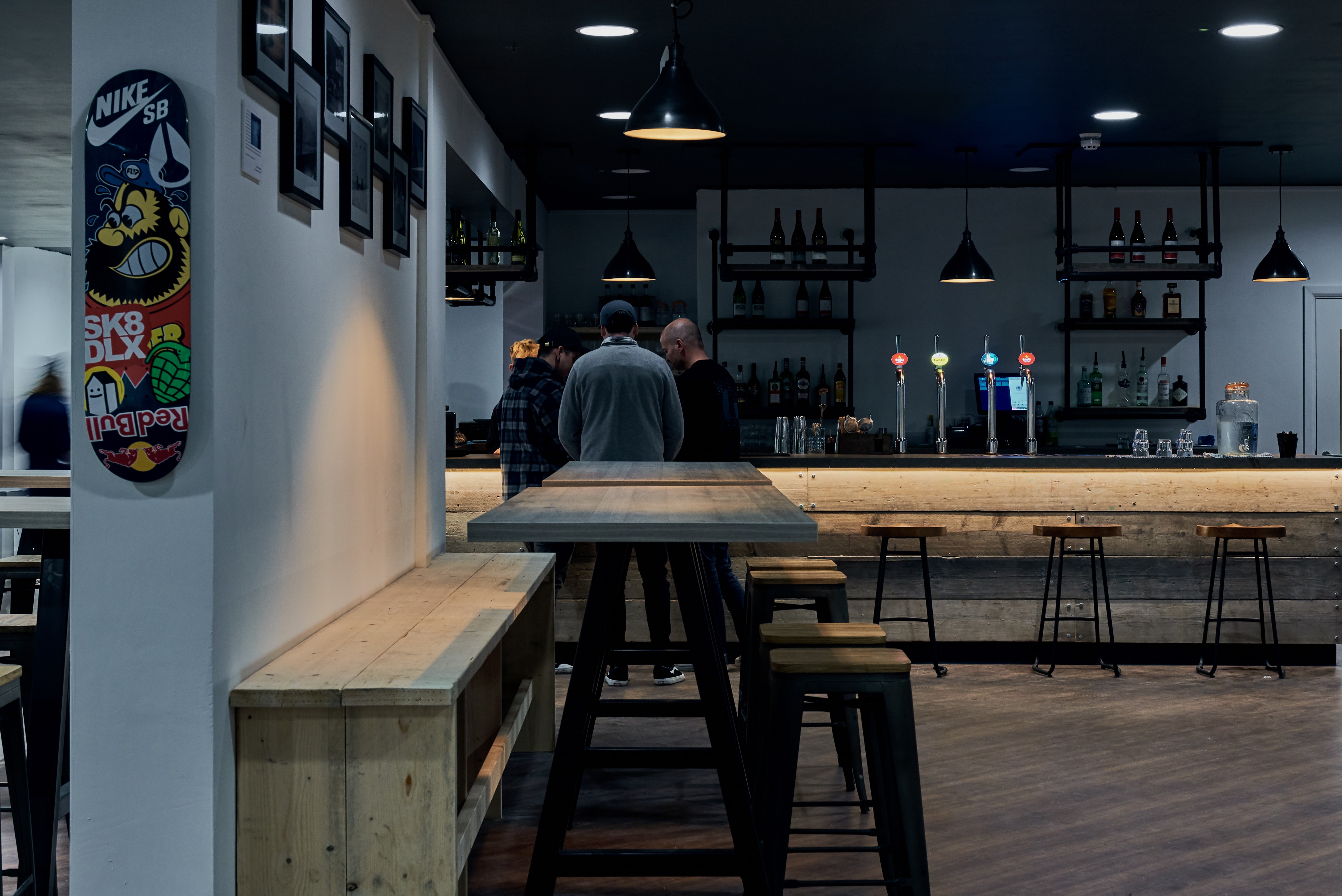 Modern bar area with wooden tables, ideal for networking events in Graystone Manchester.