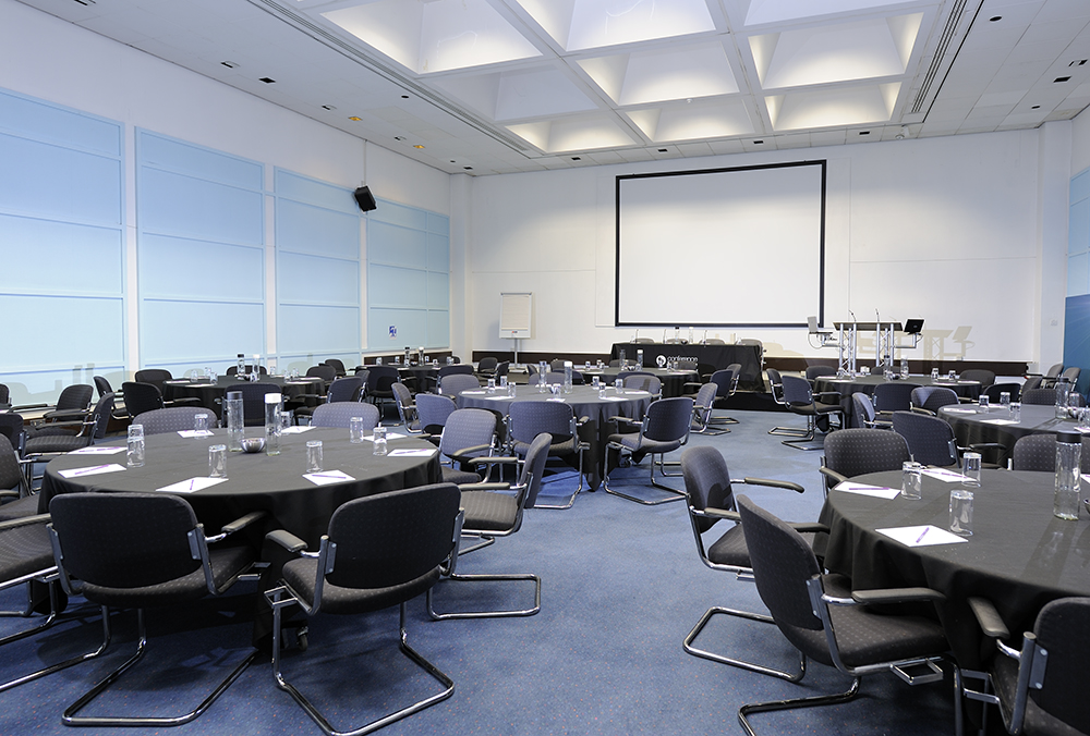 Conference Room in Fielder Centre with round tables, ideal for meetings and presentations.