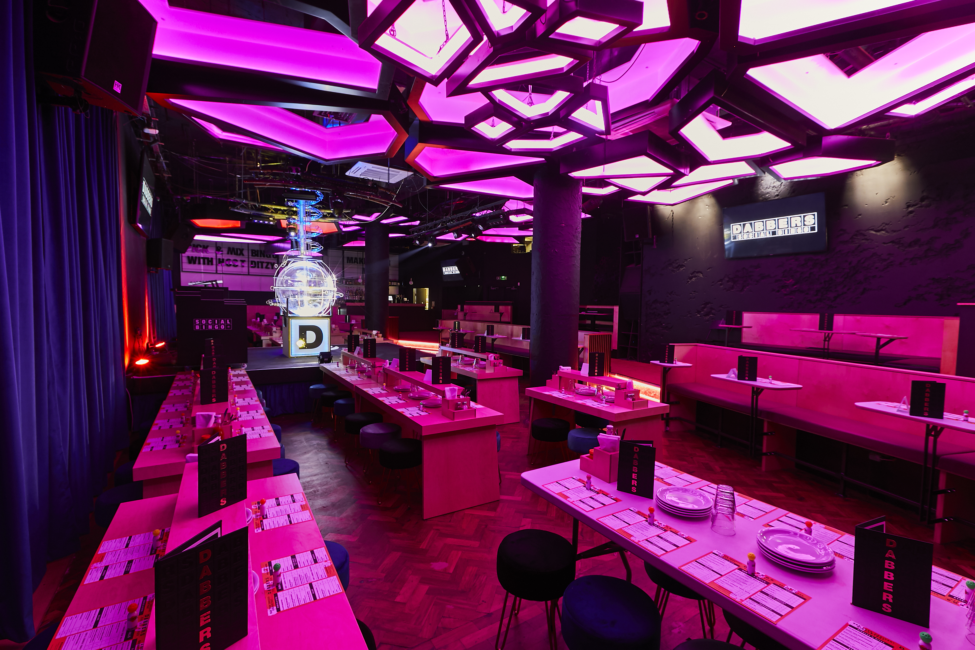 Vibrant event space at Dabbers Social Bingo with bold lighting for corporate gatherings.