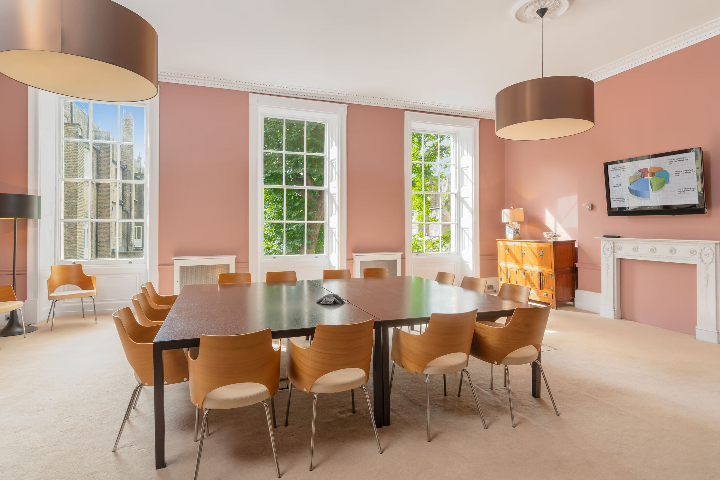 Private Gardens View Room with central table, ideal for meetings and collaboration.