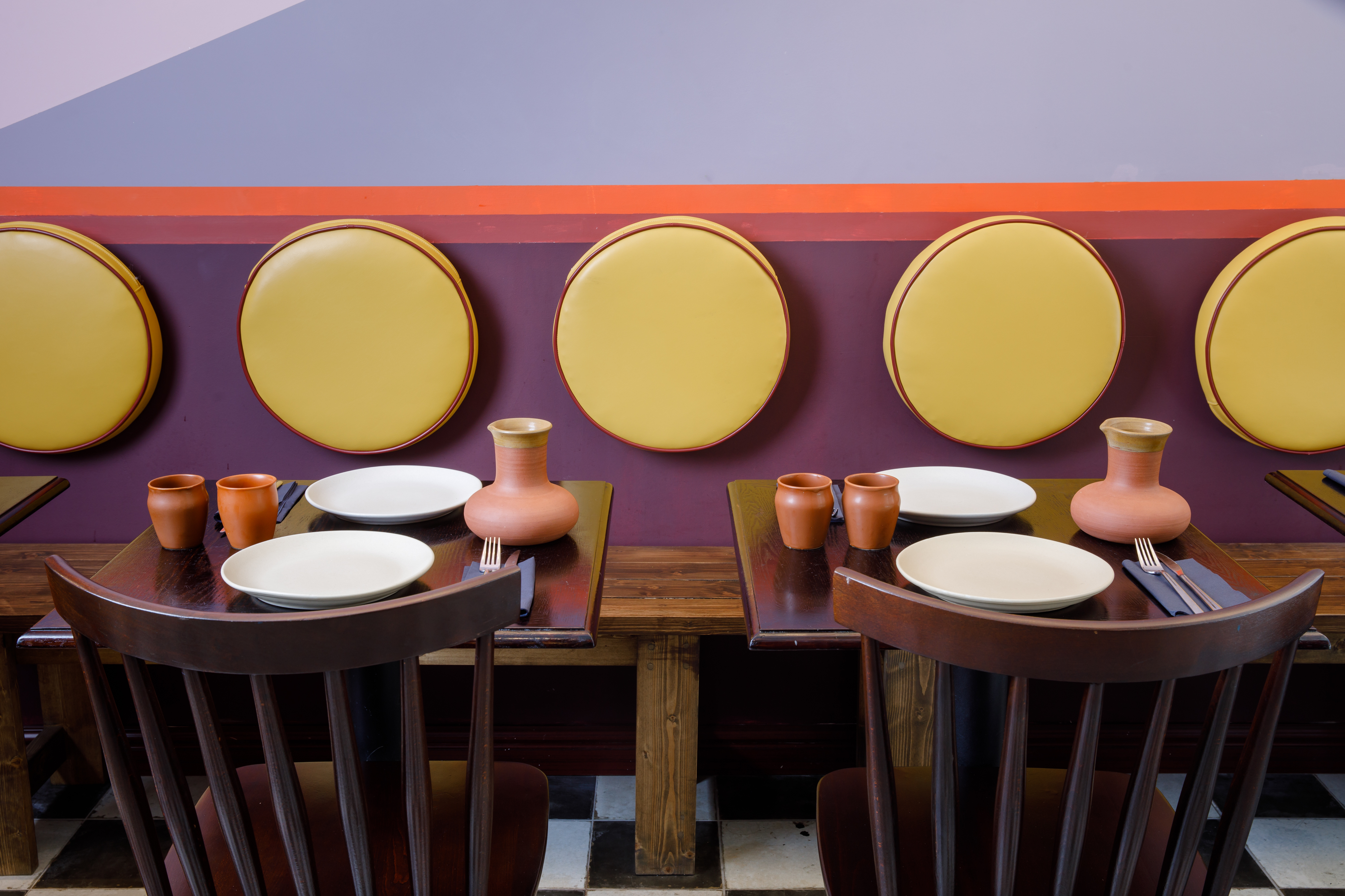 Vibrant dining space in Little Kolkata with cushioned seating for intimate gatherings