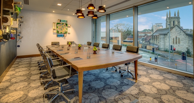 Modern conference room with oval table, ideal for meetings and presentations in Bournemouth.