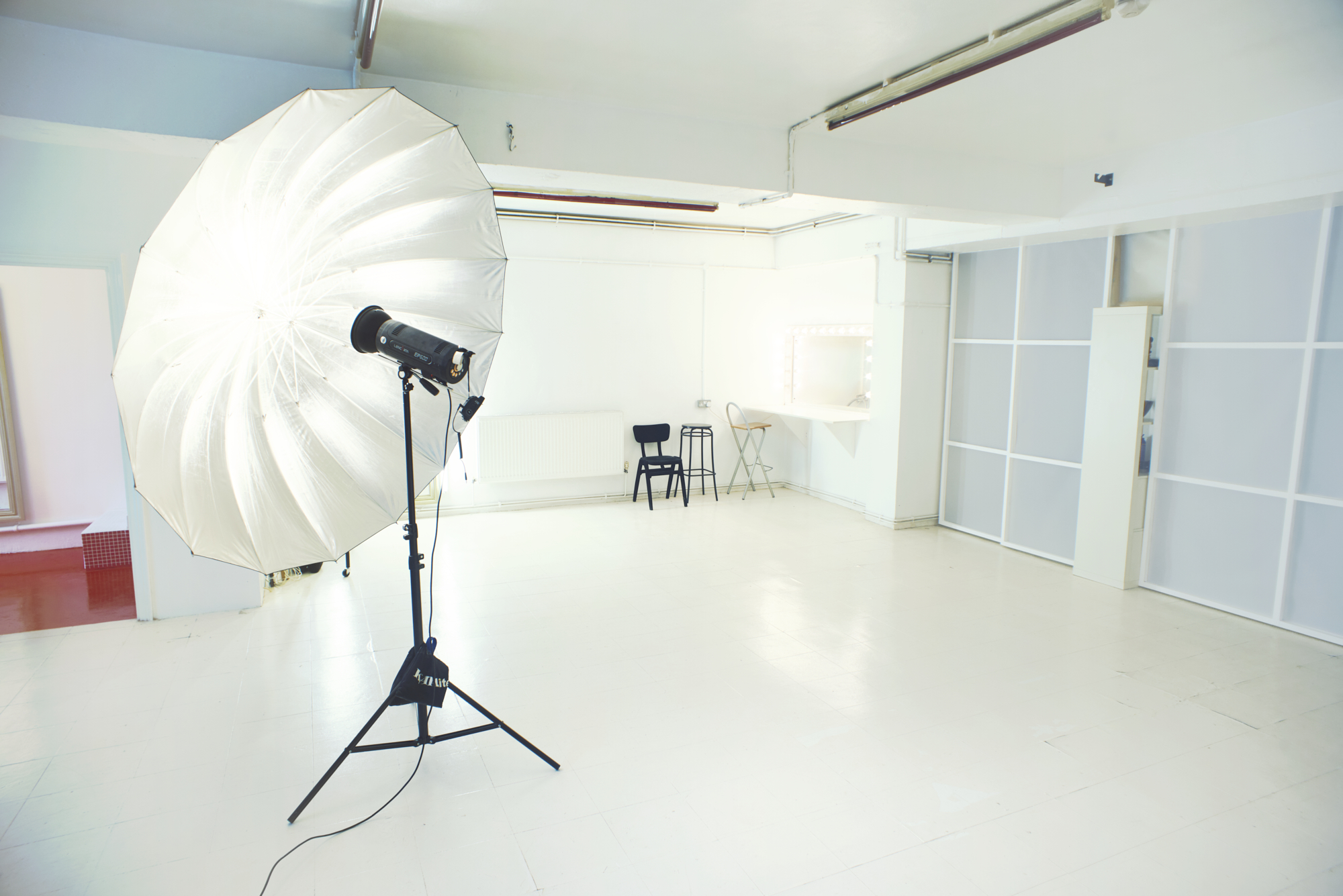 Minimalist studio venue with softbox lighting for events and creative workshops.