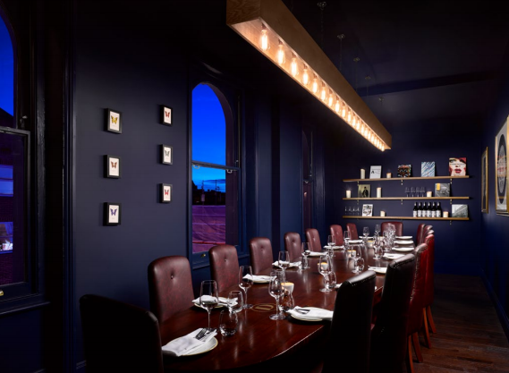 Elegant dining space in The Distillery for private events and networking dinners.