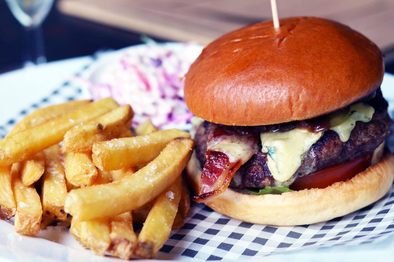 Gourmet burger with fries and coleslaw for casual event catering in Pimlico.