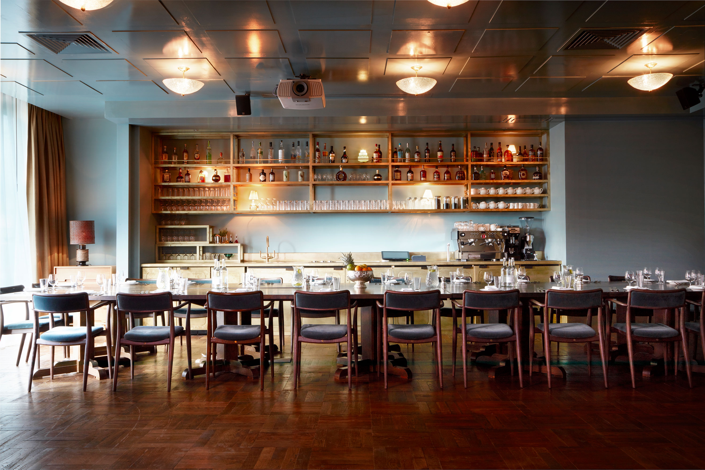 Elegant event space with long table, modern chairs for gatherings and meetings.