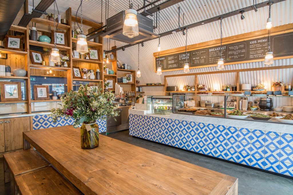 Stylish café interior with wooden table, ideal for networking and casual meetings.