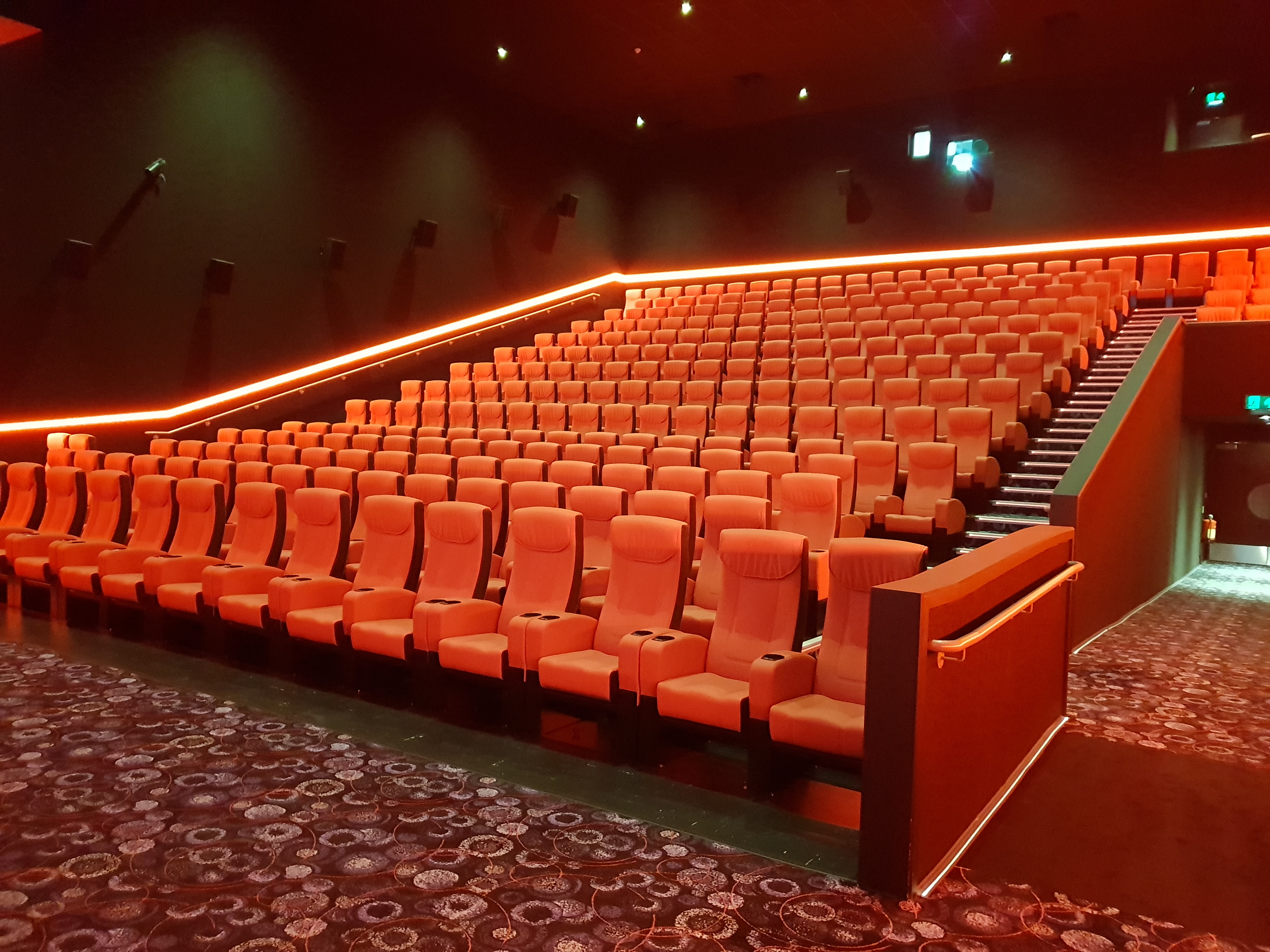Modern Cineworld Watford theater with plush orange seating for film screenings and presentations.