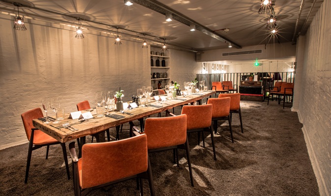 Private room in The Anthologist with elegant wooden table, ideal for corporate meetings and events.