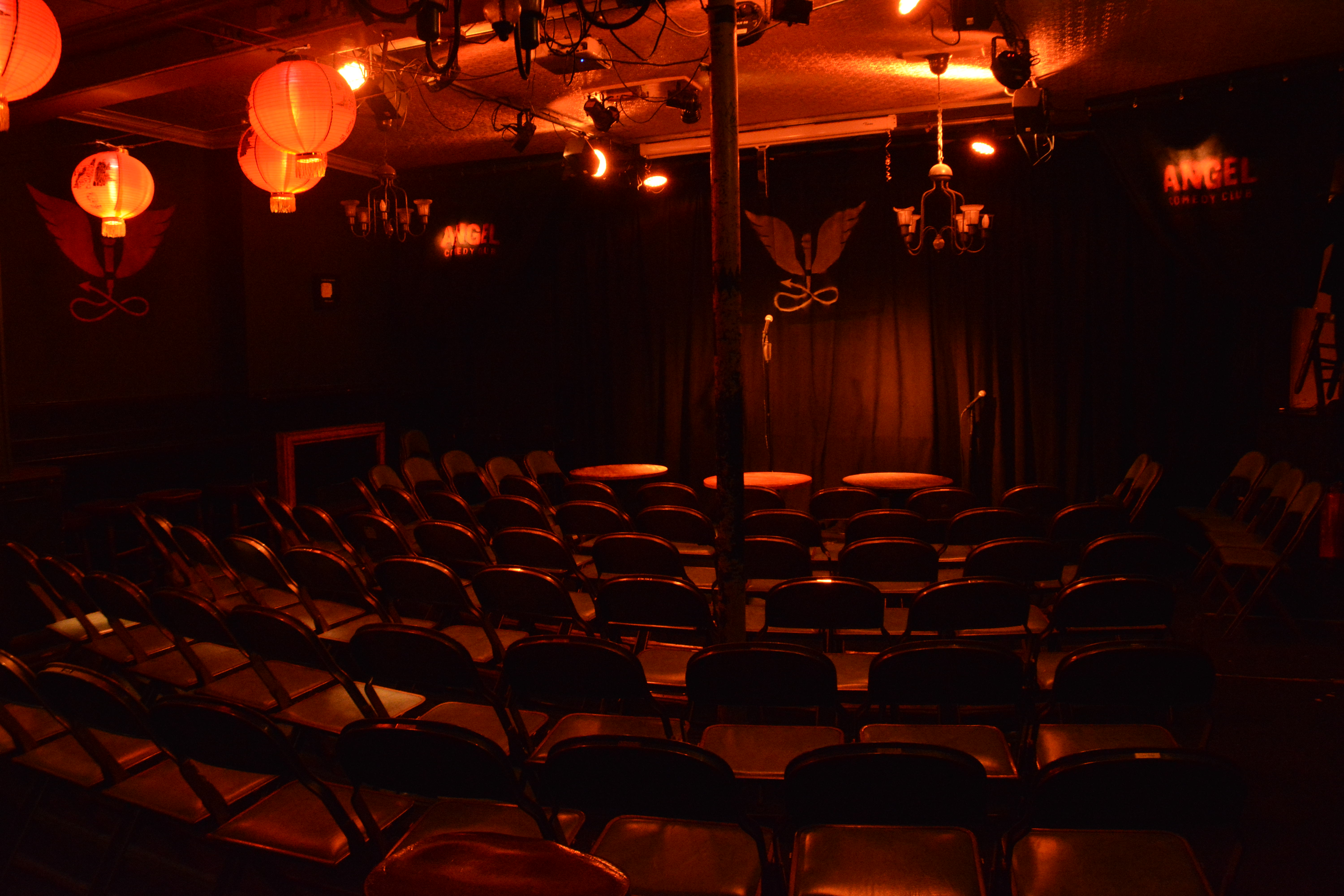 Intimate event space with red lighting for comedy nights and small concerts at The Bill Murray.