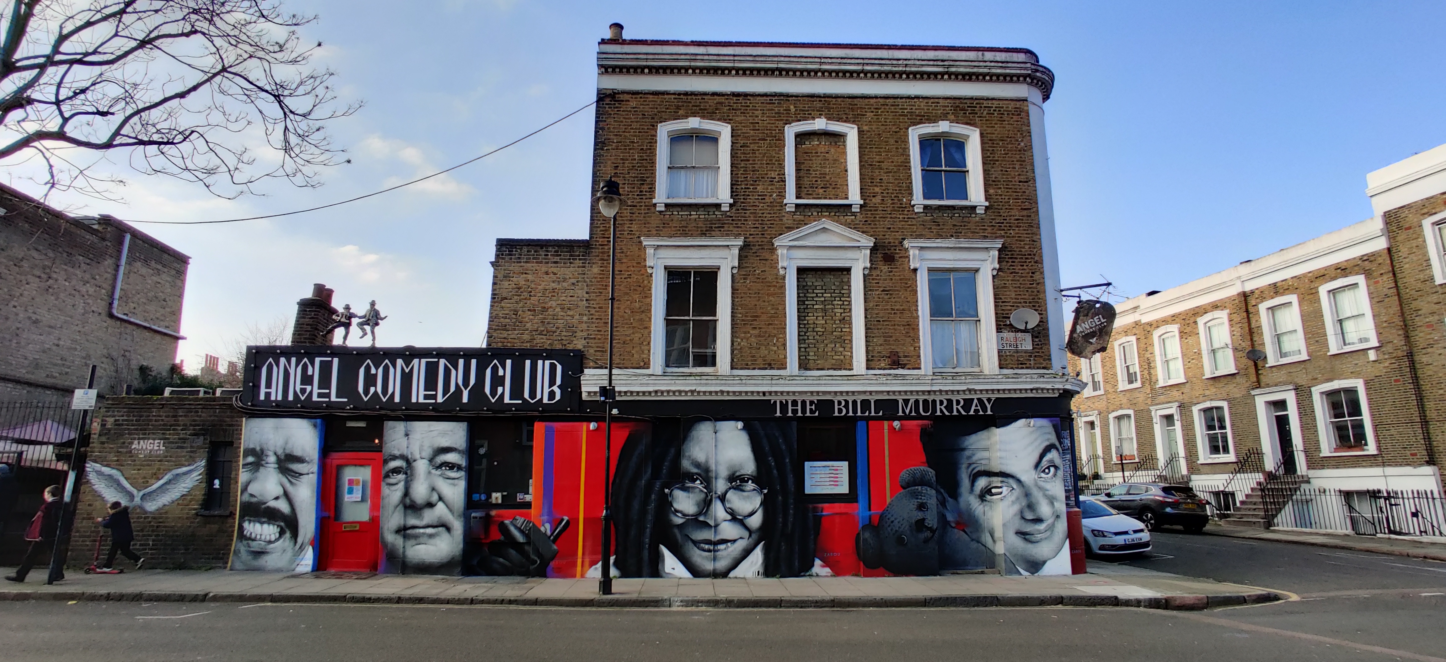 Main stage at Angel Comedy Club with vibrant murals, ideal for events and networking.