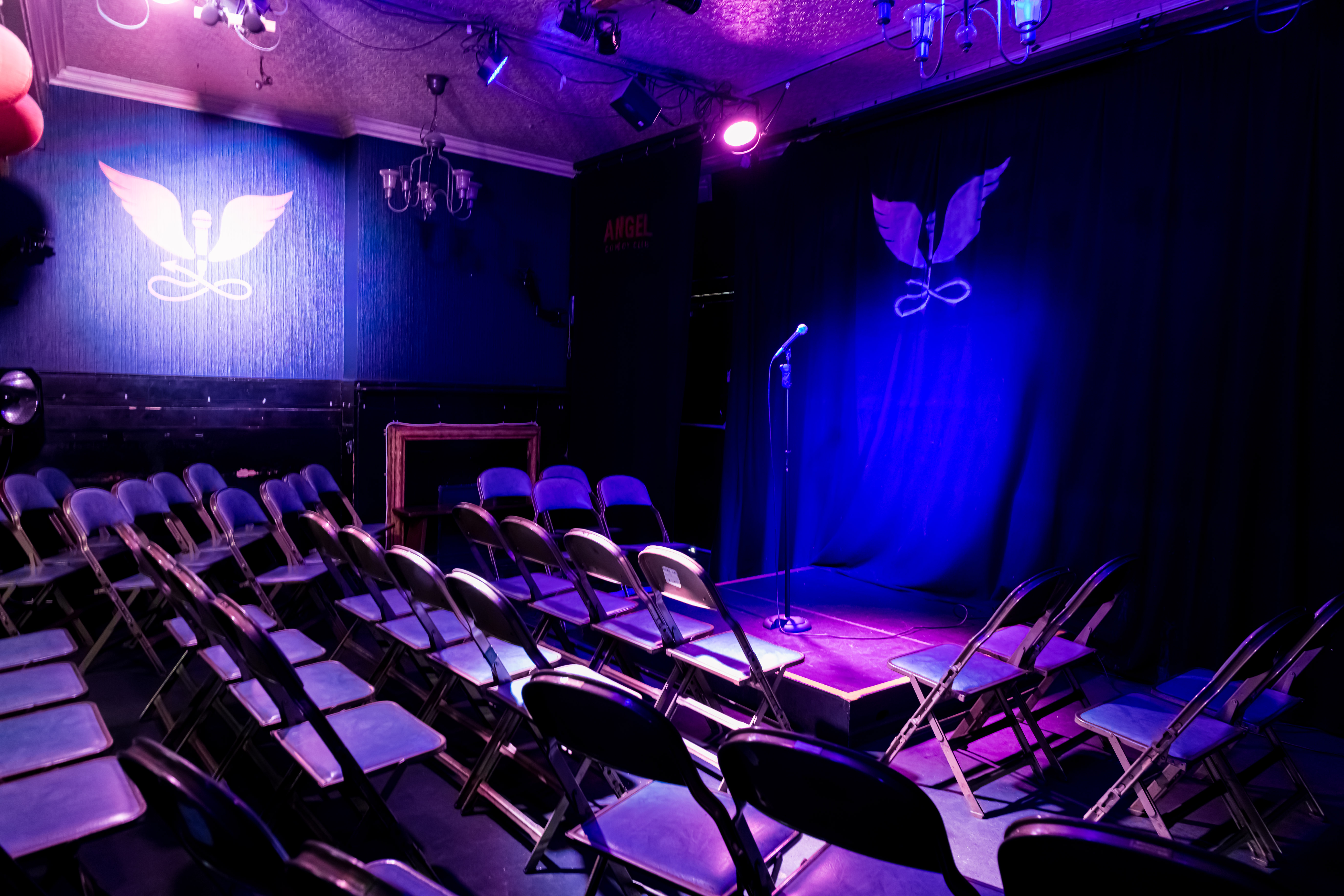 Main stage at The Bill Murray, intimate space with purple lighting for comedy events.