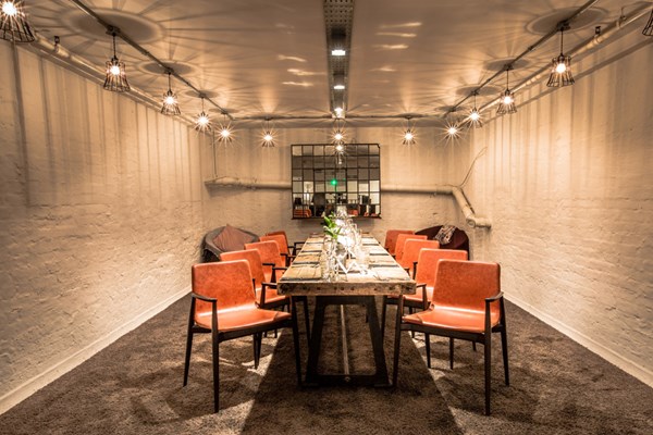 Intimate meeting space at The Anthologist with warm lighting for executive gatherings.