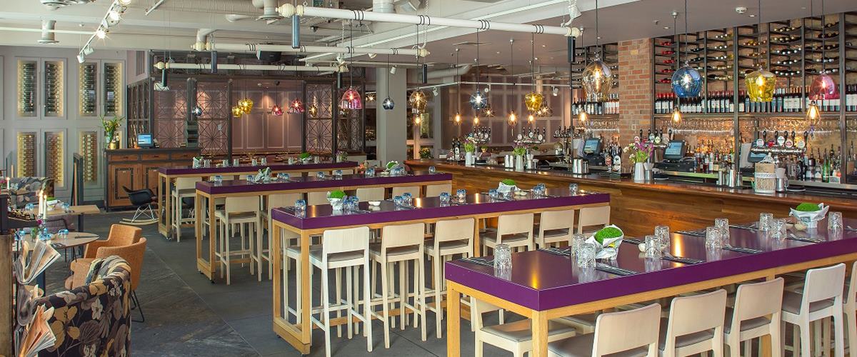 Modern restaurant venue with communal tables, perfect for events and gatherings.