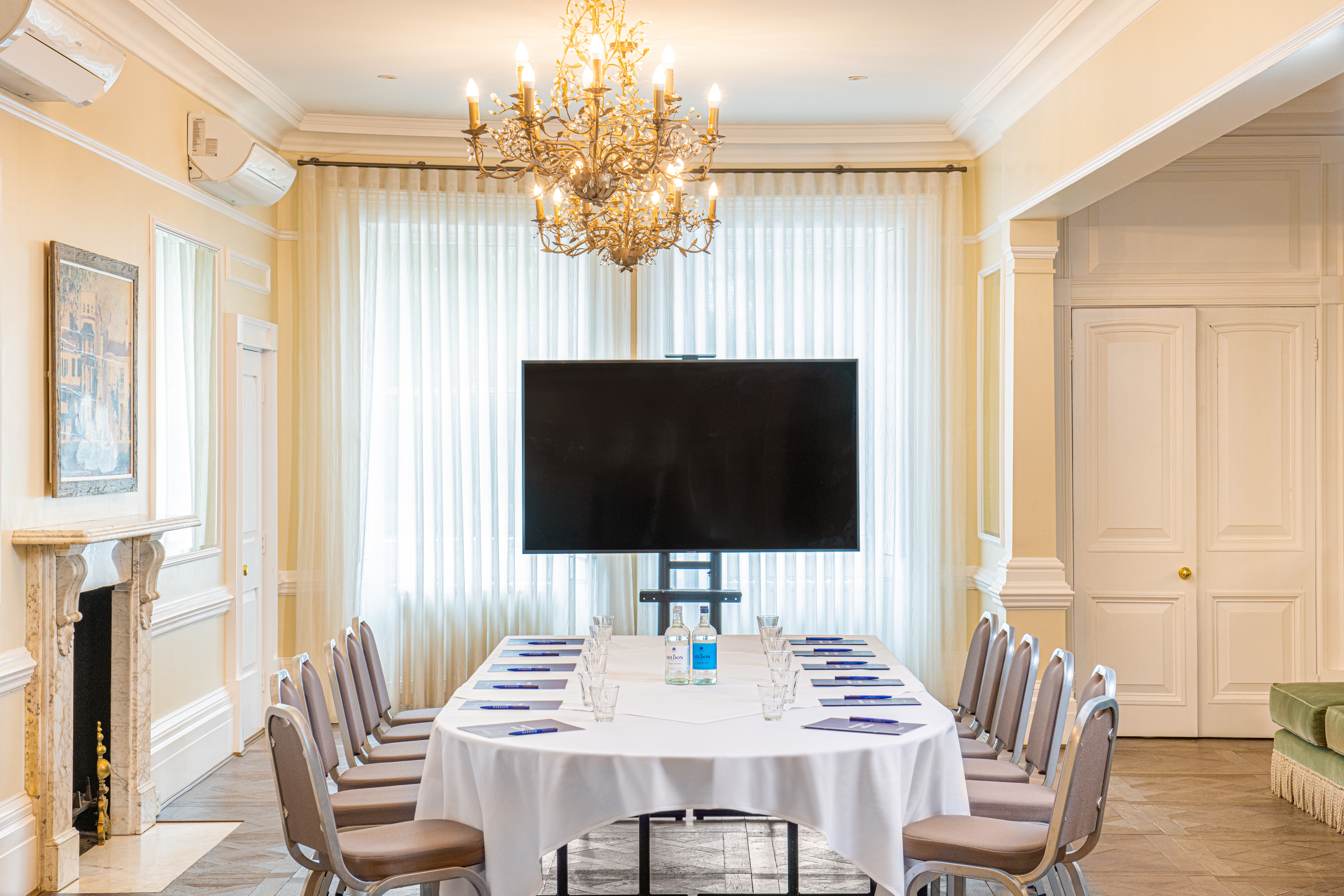 Richmond Room at Richmond Harbour Hotel, elegant meeting space with chandelier and natural light.