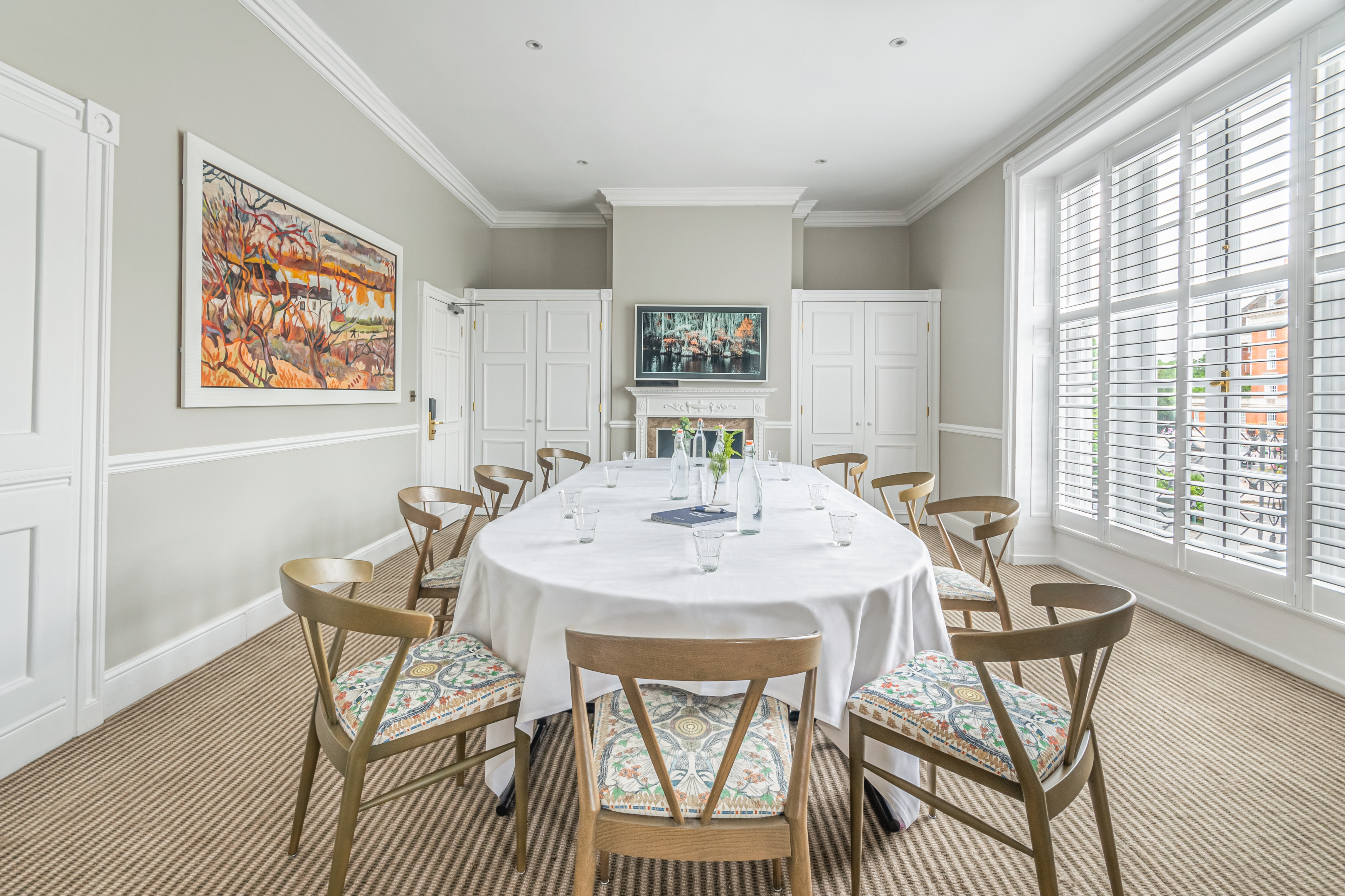 Meeting room at Richmond Harbour Hotel with round table, ideal for corporate events.