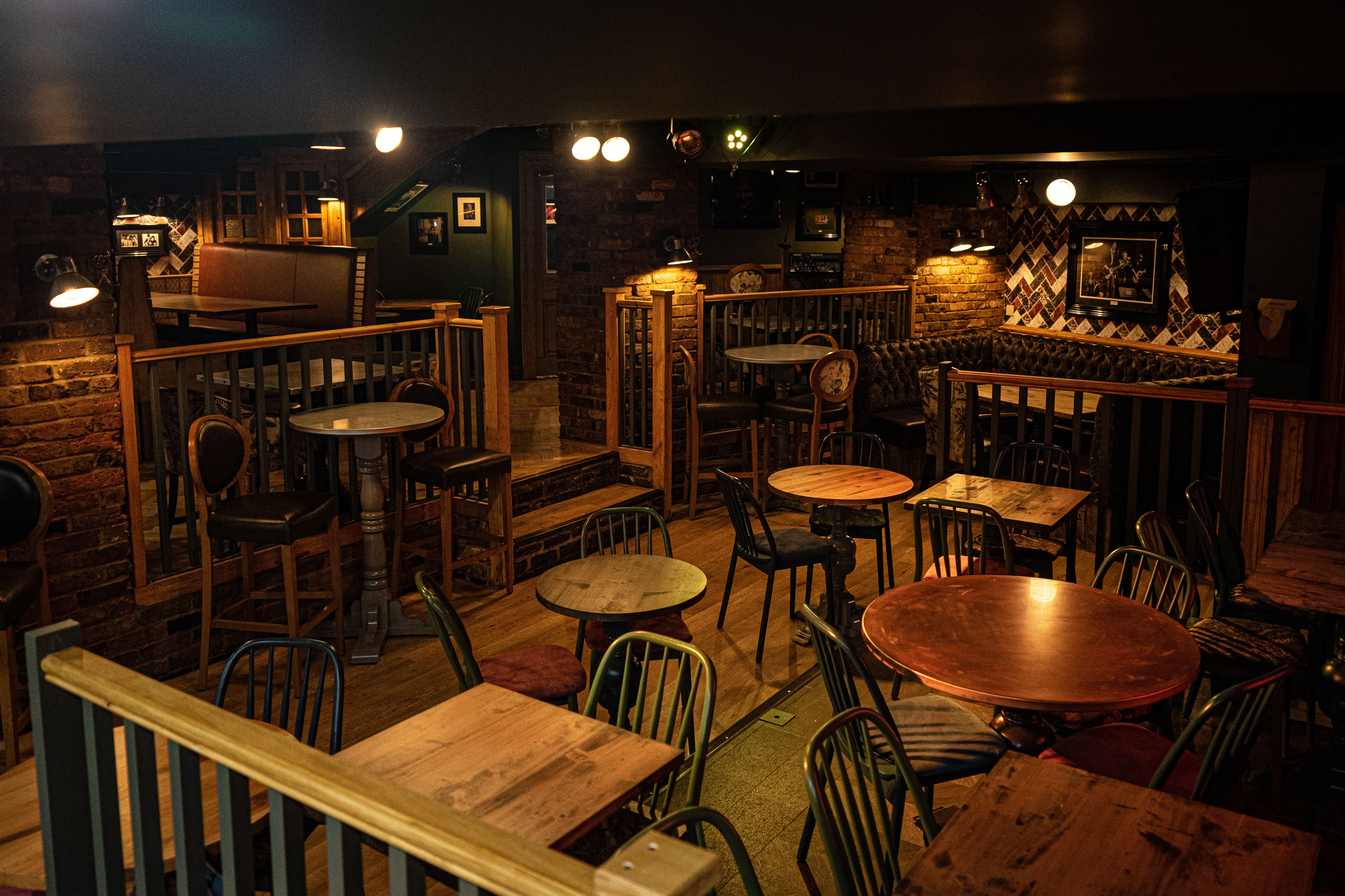 Cozy Backstage Basement event space with rustic decor for networking and gatherings.