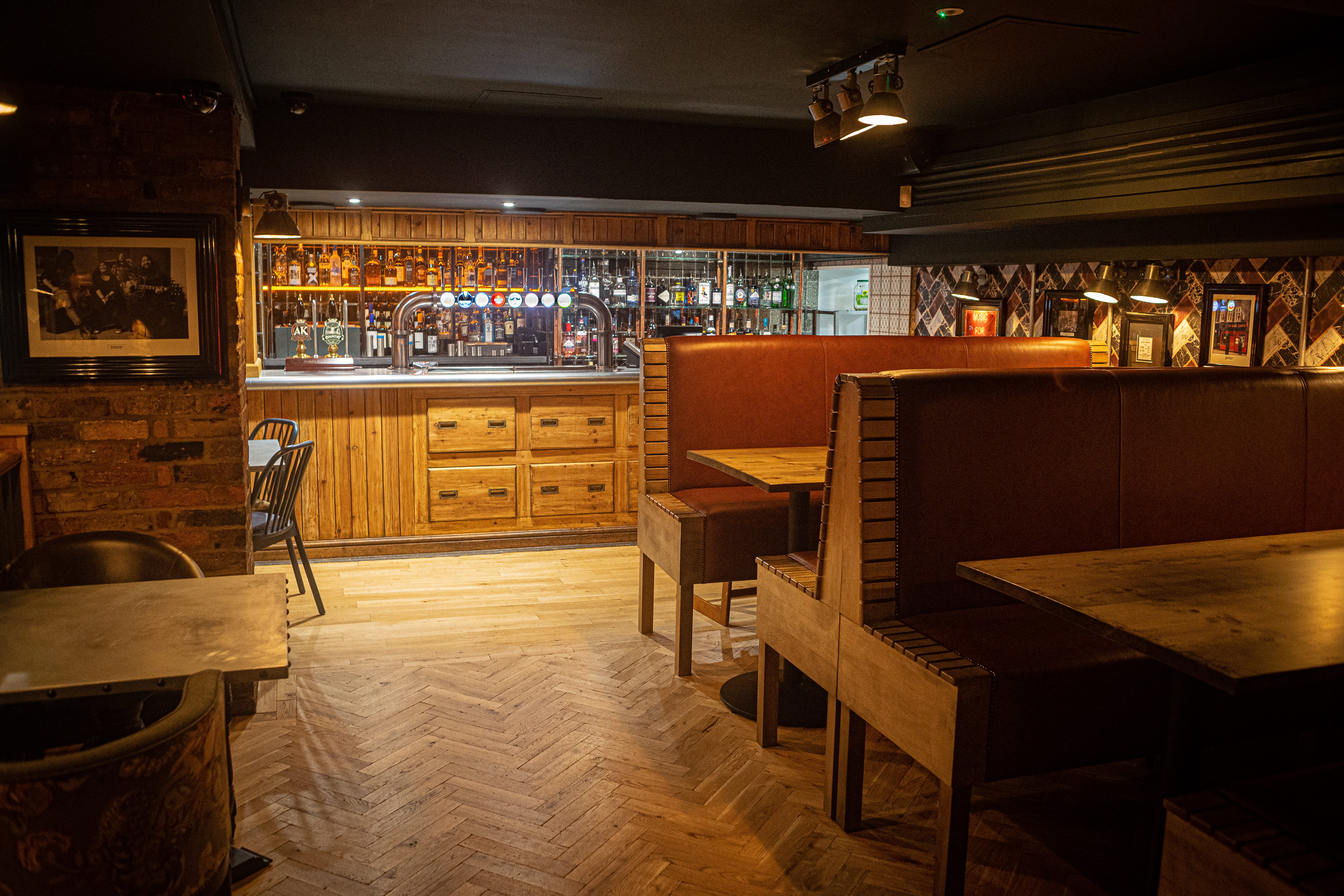 Cozy bar setting with warm wood tones, ideal for networking events and informal meetings.