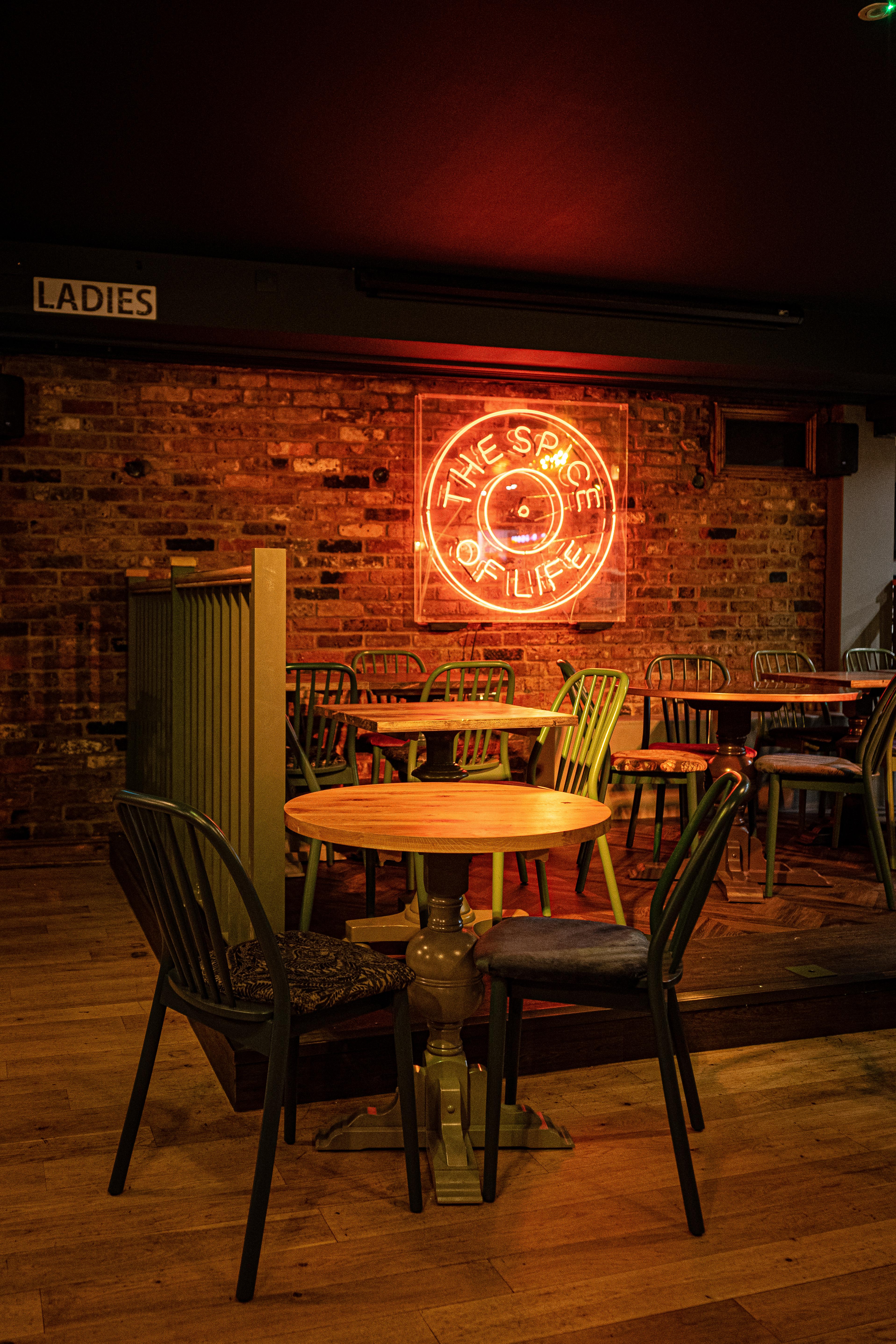 Cozy Backstage Basement venue with rustic brick walls, perfect for intimate events.