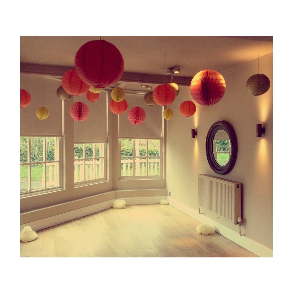 Charming event space with colorful lanterns at The Lyttelton Arms for celebrations.