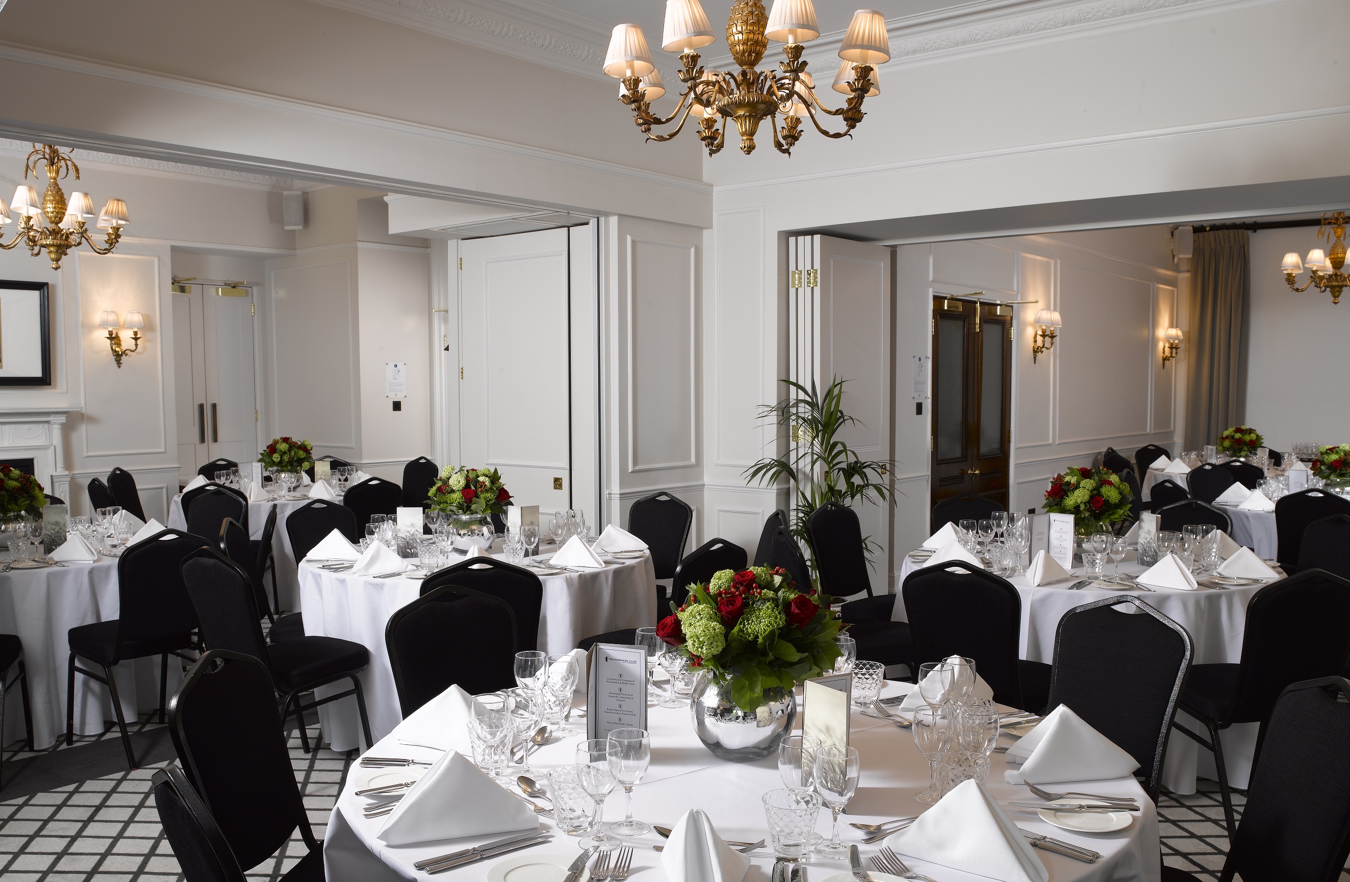 Elegant banquet room with round tables, ideal for corporate events and weddings.