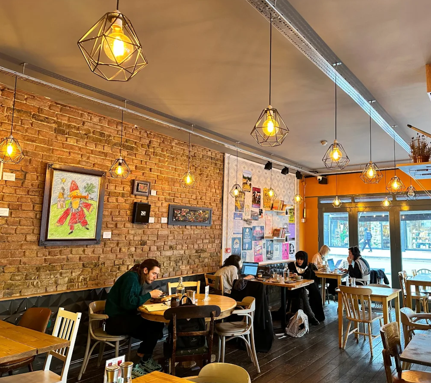 Cozy café venue with warm lighting, ideal for informal meetings and small events.