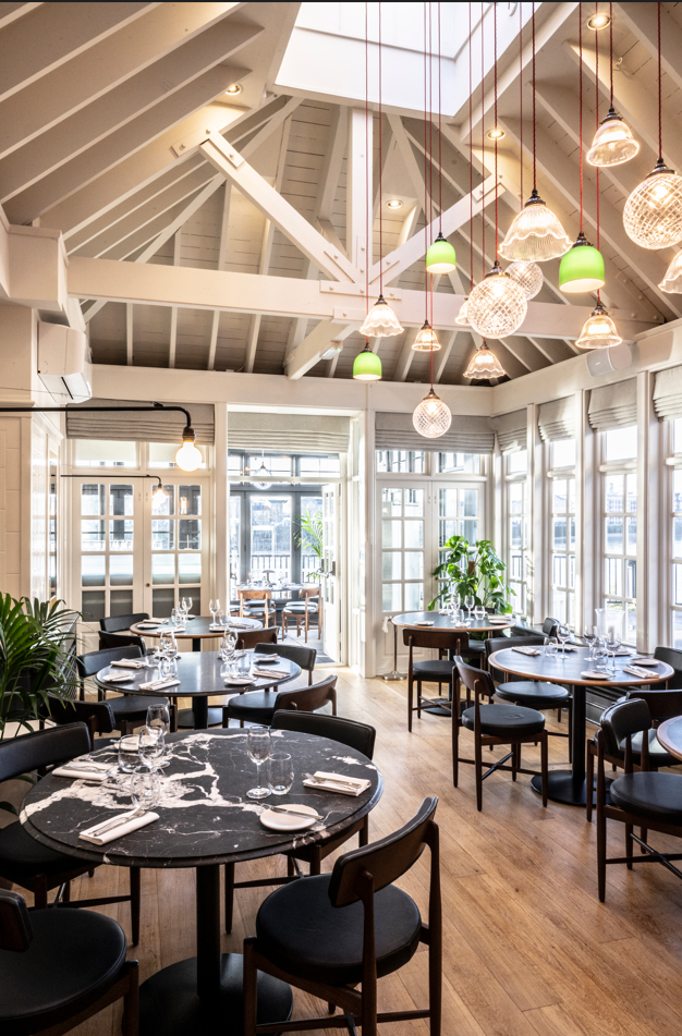Stylish restaurant venue with round tables for intimate meetings and events in Limehouse.