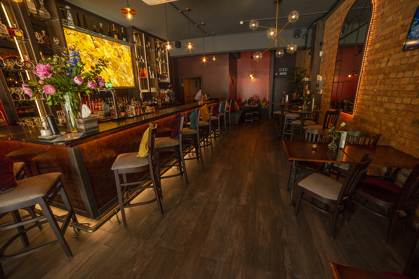 Stylish bar venue with warm lighting, perfect for intimate gatherings and networking events.