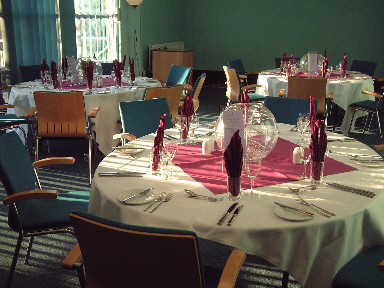 Elegant event space with round tables, ideal for corporate gatherings and banquets.