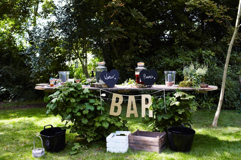 Outdoor bar setup in Secret River Garden, perfect for summer parties and casual events.