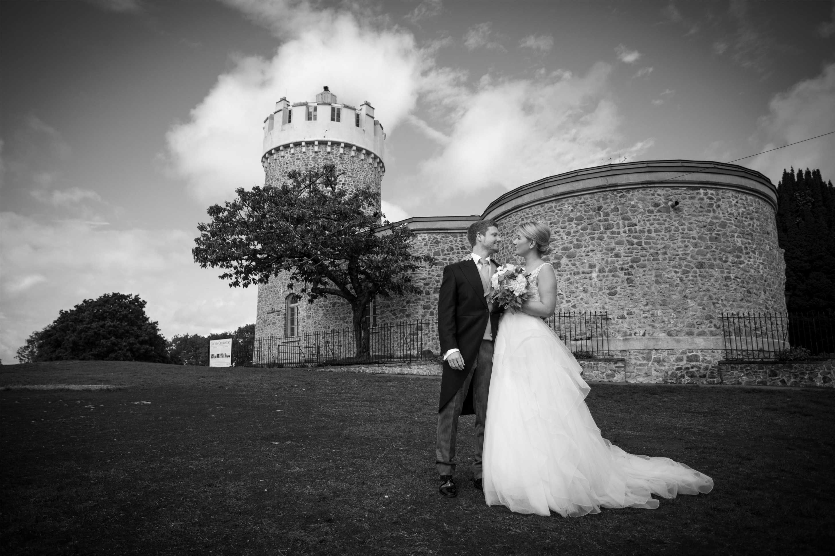 Elegant outdoor wedding at Clifton Observatory with lush greenery and historic backdrop.