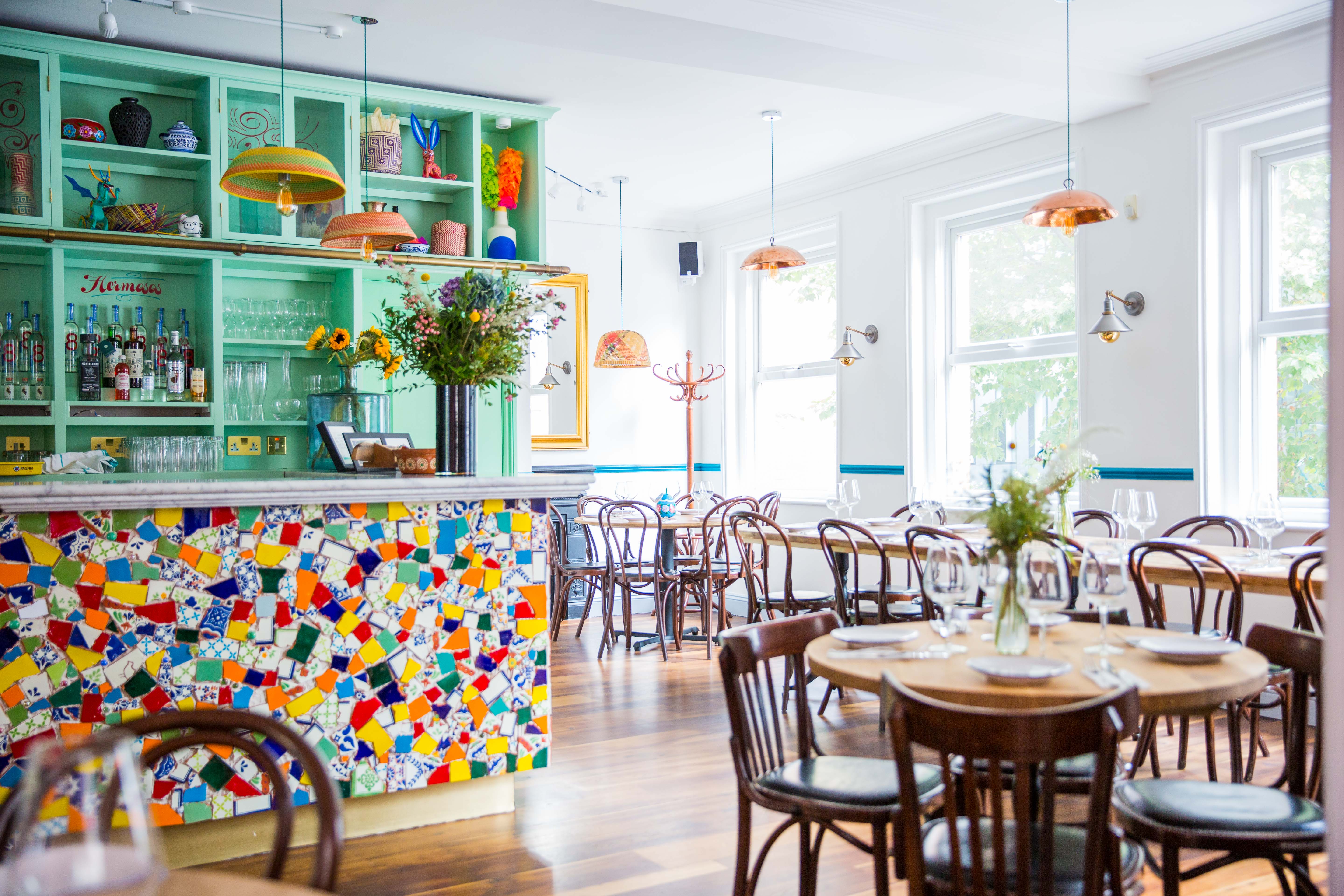 Agave dining room with colorful mosaic bar, ideal for networking events and celebrations.