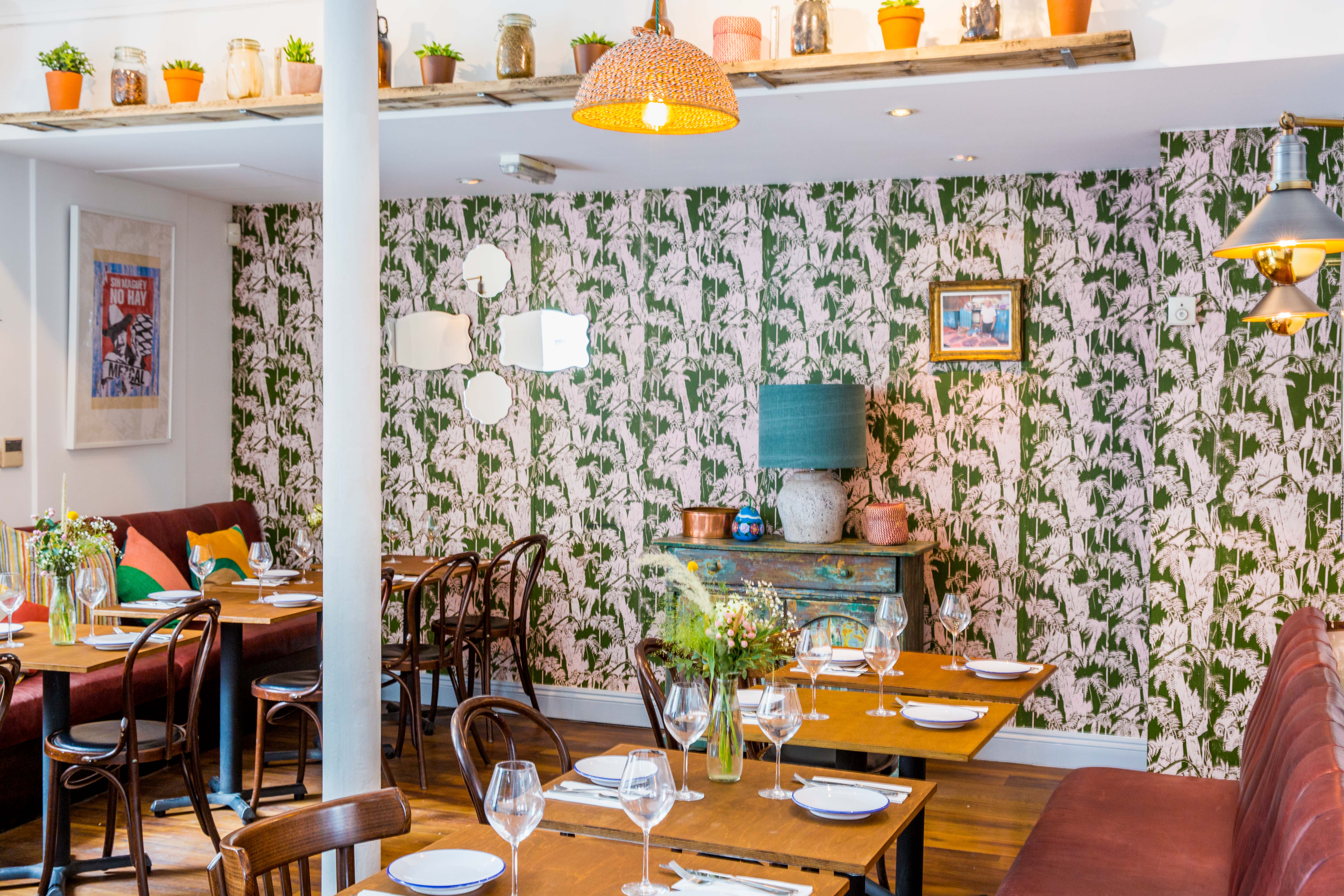 Agave dining room with floral wallpaper, ideal for networking events and casual dining.