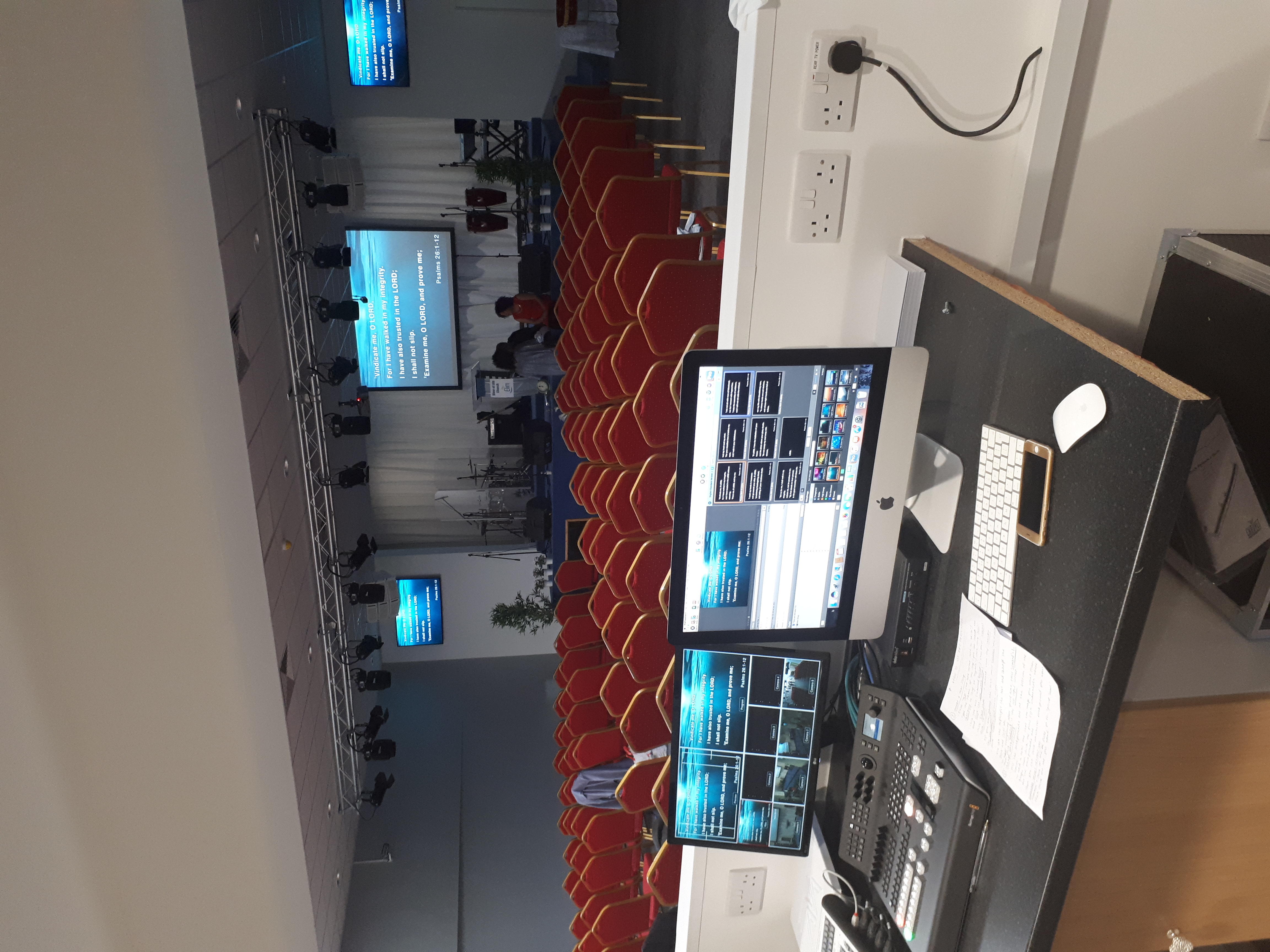Business conference room with AV setup and red chairs for effective presentations.