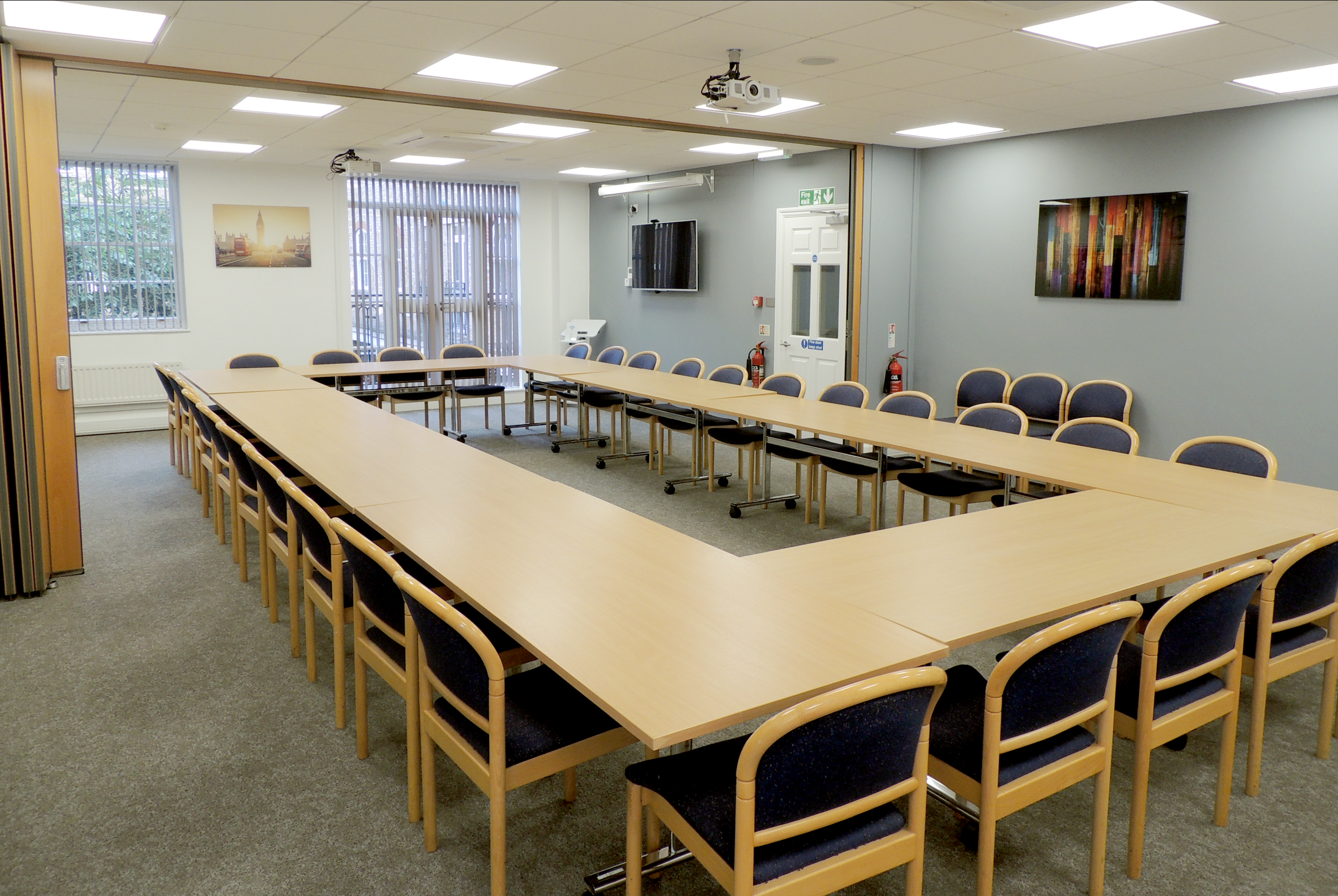 Meeting room with U-shaped table, ideal for corporate events and presentations.